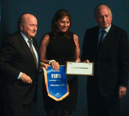 Laura Macchiotti receives  FIFA/CIES award from Joseph Blatter and Bertrand Reeb