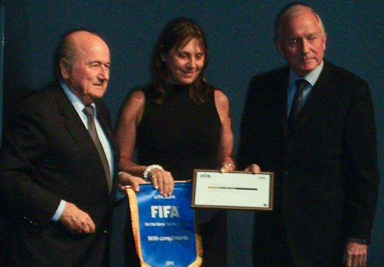 Laura Macchiotti receives  FIFA/CIES award from Joseph Blatter and Bertrand Reeb